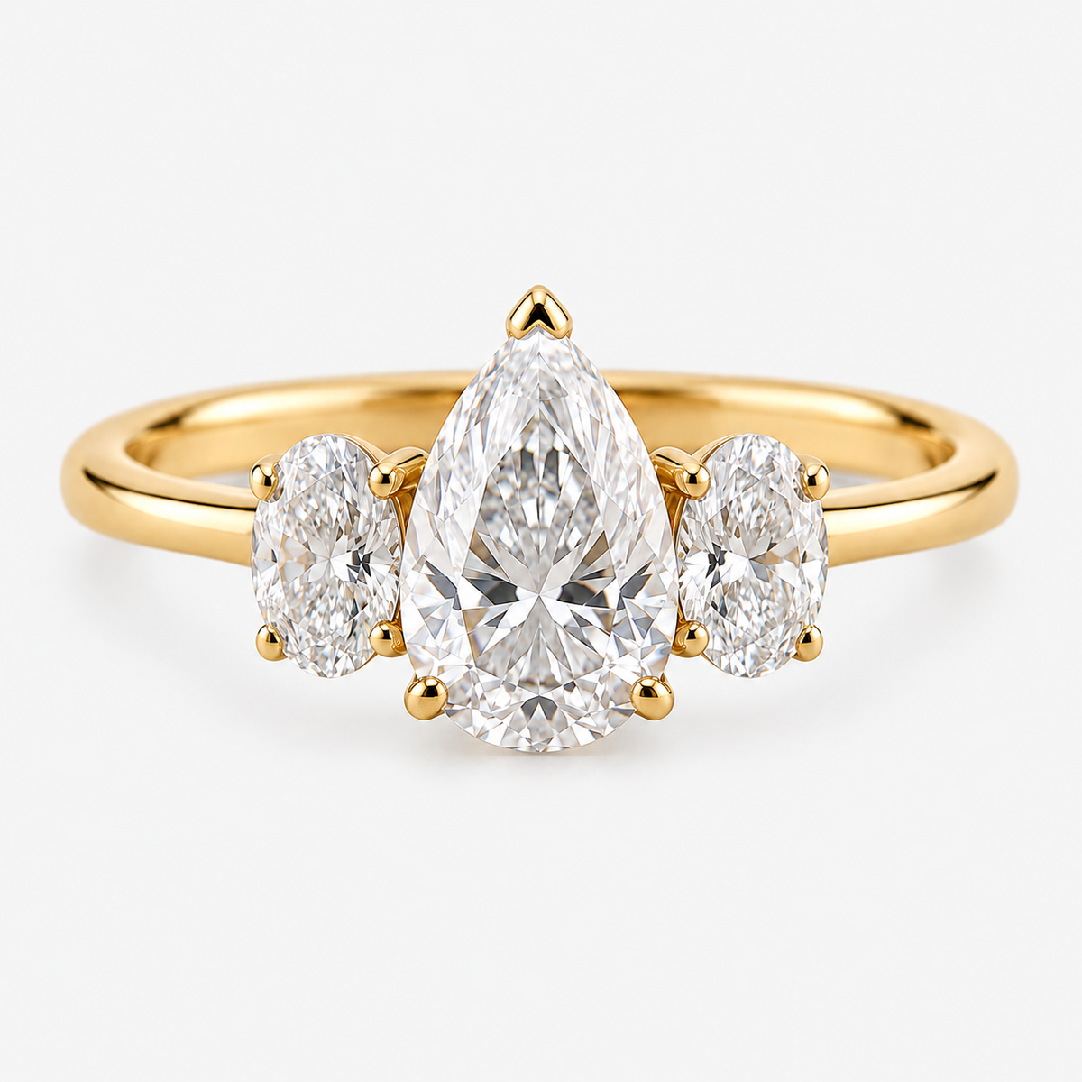 Lab Grown Diamond Pear Cut Three Stone Engagement Ring with Oval Side Stones in 14K Yellow Gold