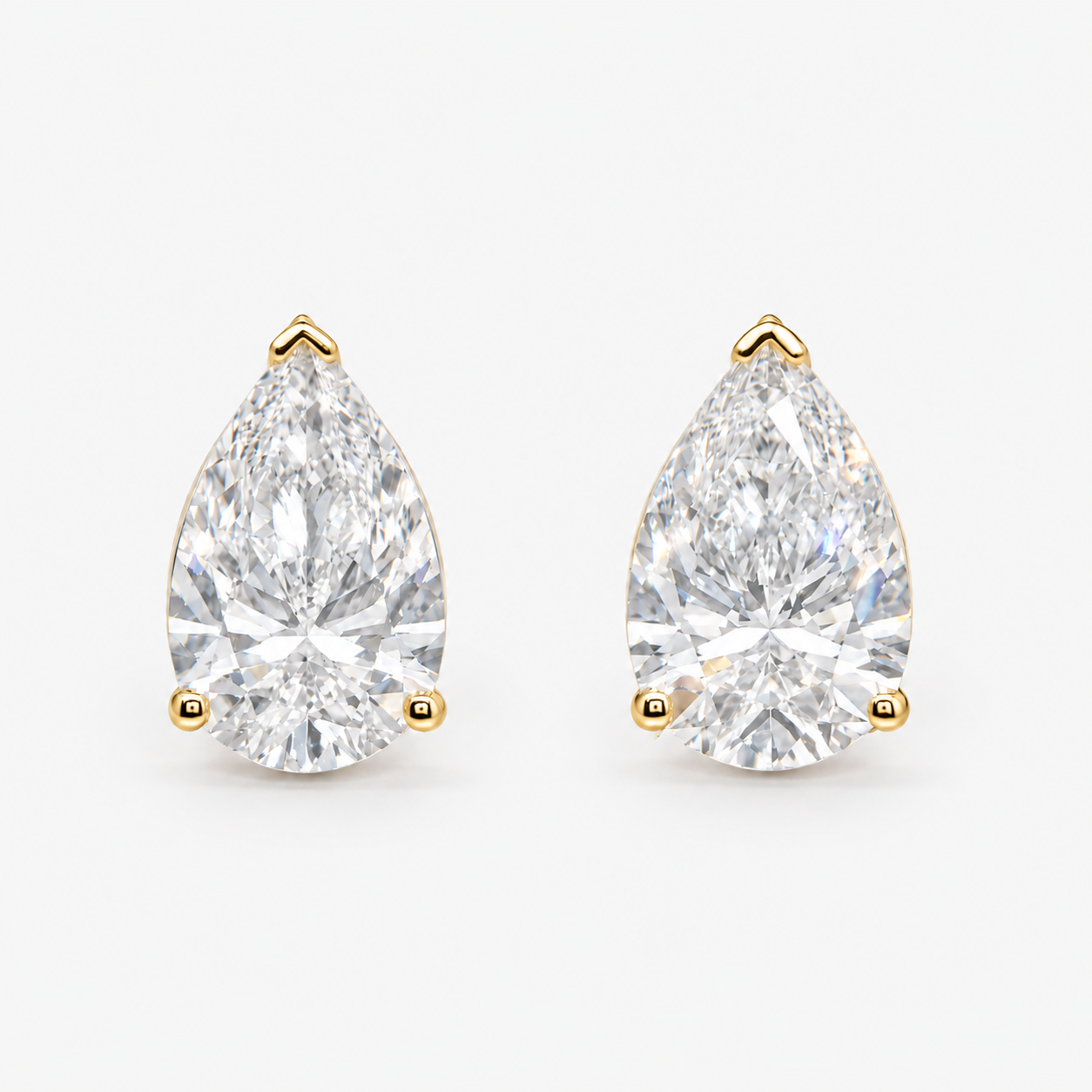 Lab Grown Diamond Pear Cut Three-Prong V-Cap Setting Stud Earrings IGI Certified in 14K Yellow Gold