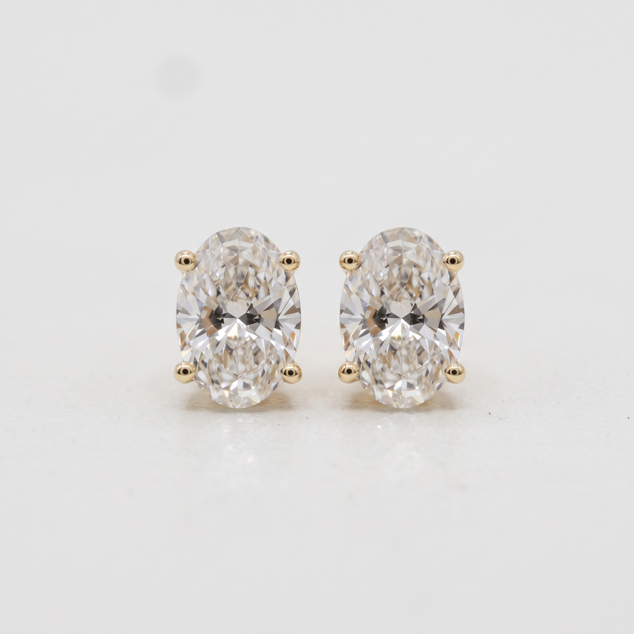 Lab Grown Oval Brilliant Cut Diamond Solitaire Stud Earring with Four-Prong Setting in 14K Yellow Gold