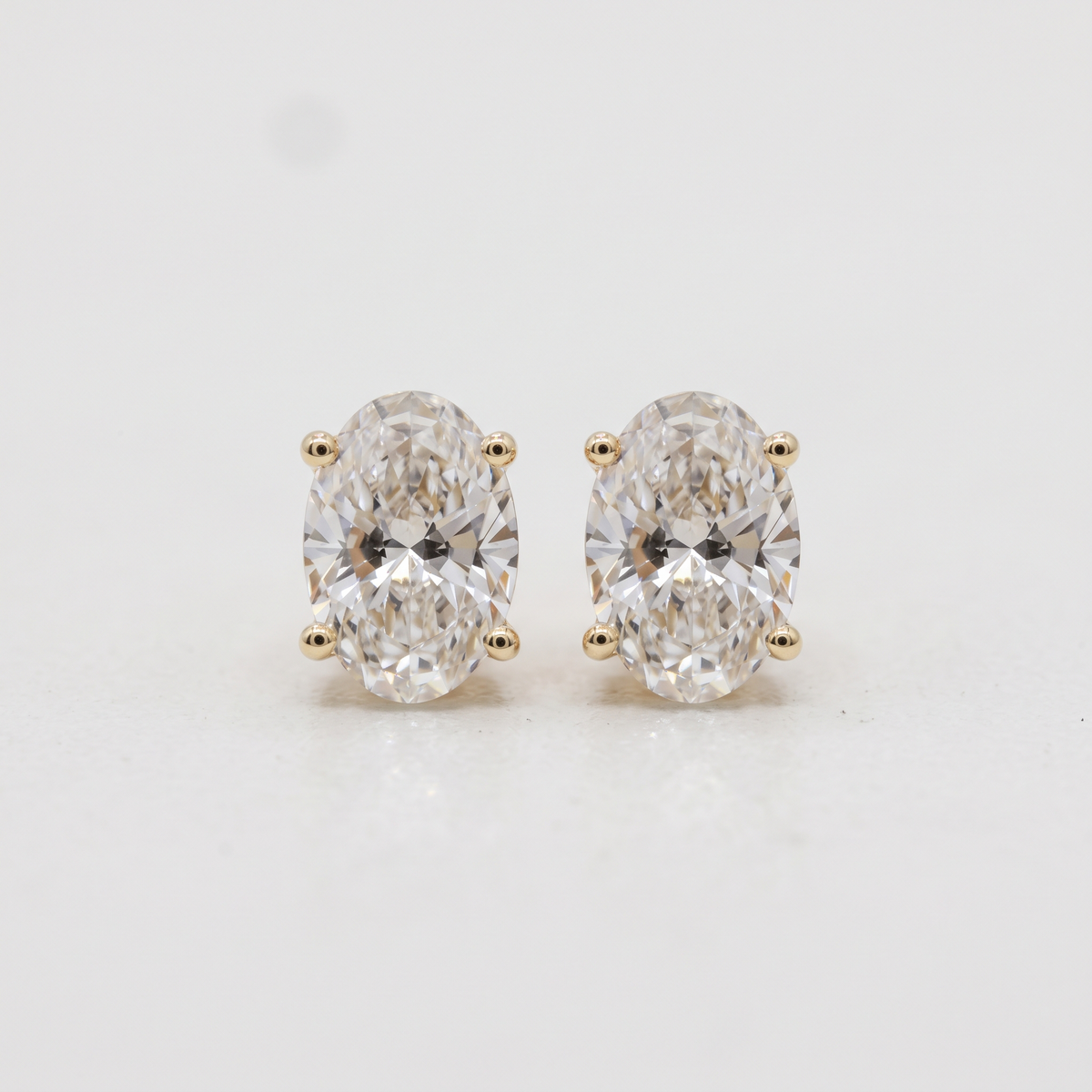 Lab Grown Oval Brilliant Cut Diamond Solitaire Stud Earring with Four-Prong Setting in 14K Yellow Gold