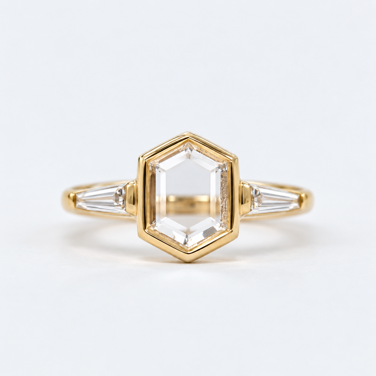 Lab Grown Diamond   Elongated Hexagon Portrait Cut Lab Grown Diamond Three Stone Engagement Ring   with Bezel Set Center and Tapered Baguette Side Diamonds in 14K Yellow Gold