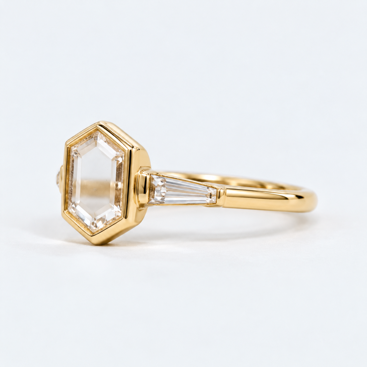 Lab Grown Diamond   Elongated Hexagon Portrait Cut Lab Grown Diamond Three Stone Engagement Ring   with Bezel Set Center and Tapered Baguette Side Diamonds in 14K Yellow Gold