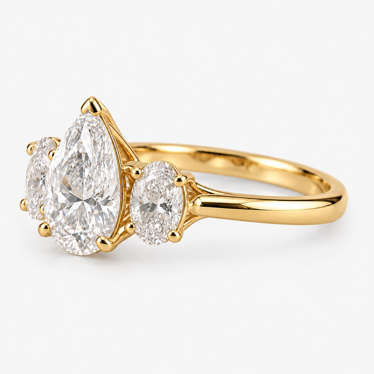 Lab Grown Diamond Pear Cut Three Stone Engagement Ring with Oval Side Stones in 14K Yellow Gold