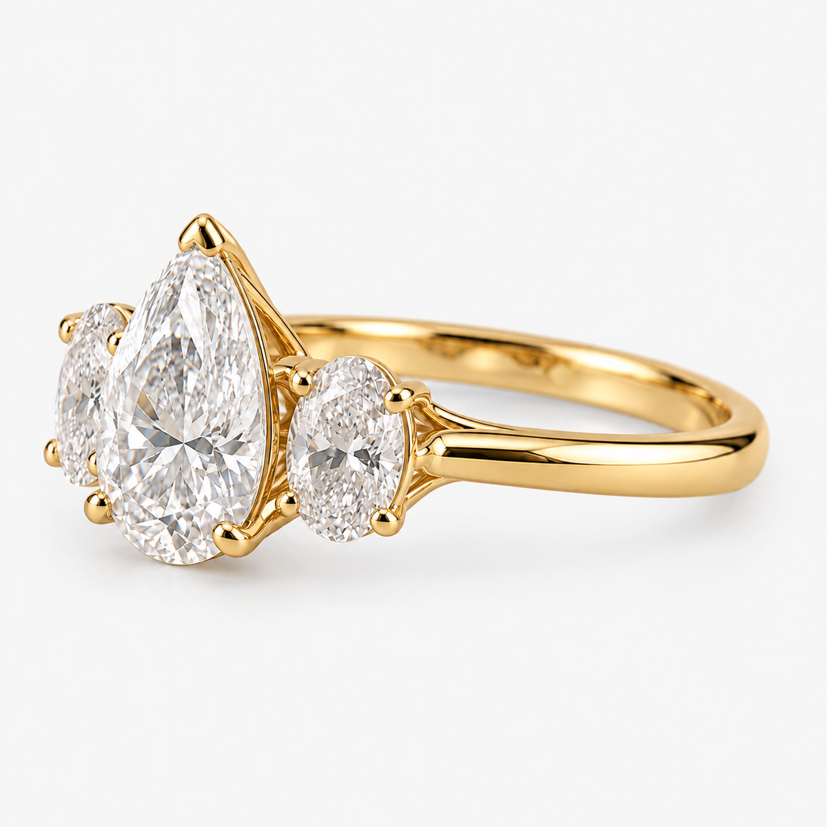 Lab Grown Diamond Pear Cut Three Stone Engagement Ring with Oval Side Stones in 14K Yellow Gold