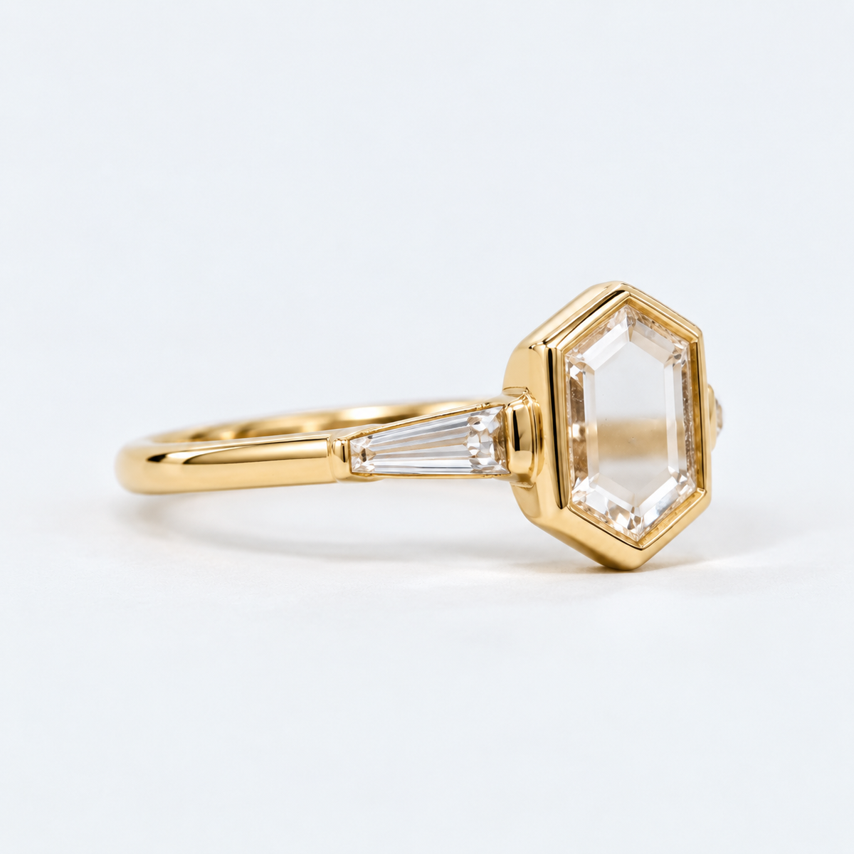 Lab Grown Diamond   Elongated Hexagon Portrait Cut Lab Grown Diamond Three Stone Engagement Ring   with Bezel Set Center and Tapered Baguette Side Diamonds in 14K Yellow Gold