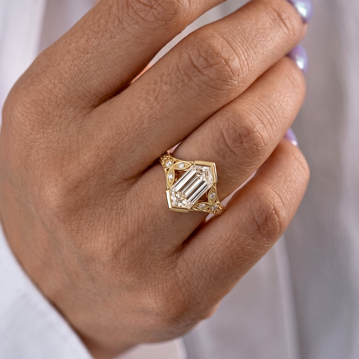 Lab Grown Diamond Elongated Hexagon Step Cut Vintage Filigree Engraved Bezel Engagement Ring with Round Side Accents IGI Certified in 14K Yellow Gold