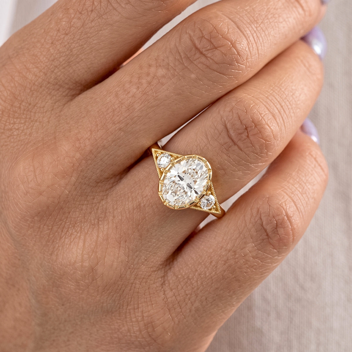 Lab Grown Diamond Oval Cut Vintage Milgrain Bezel Three-Stone Engagement Ring with Round Side Accents IGI Certified in 14K Yellow Gold