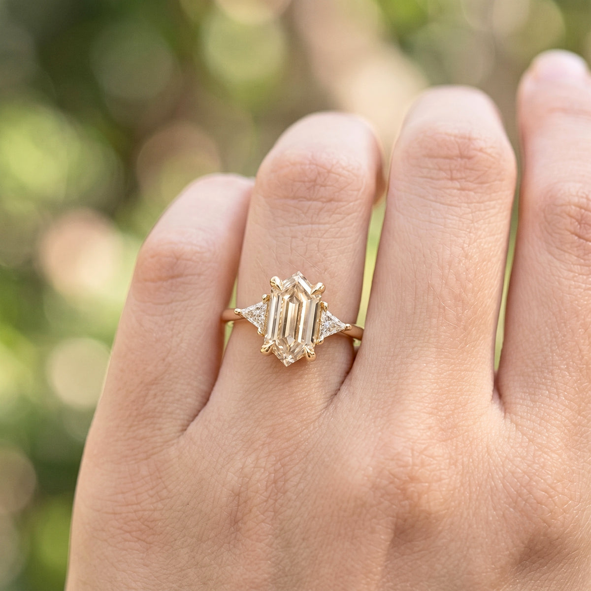 Lab Grown Diamond Elongated Hexagon Step Cut Classic Plain Solitaire Engagement Ring with Triangle Trillion Side Accents IGI Certified in 14K Yellow Gold