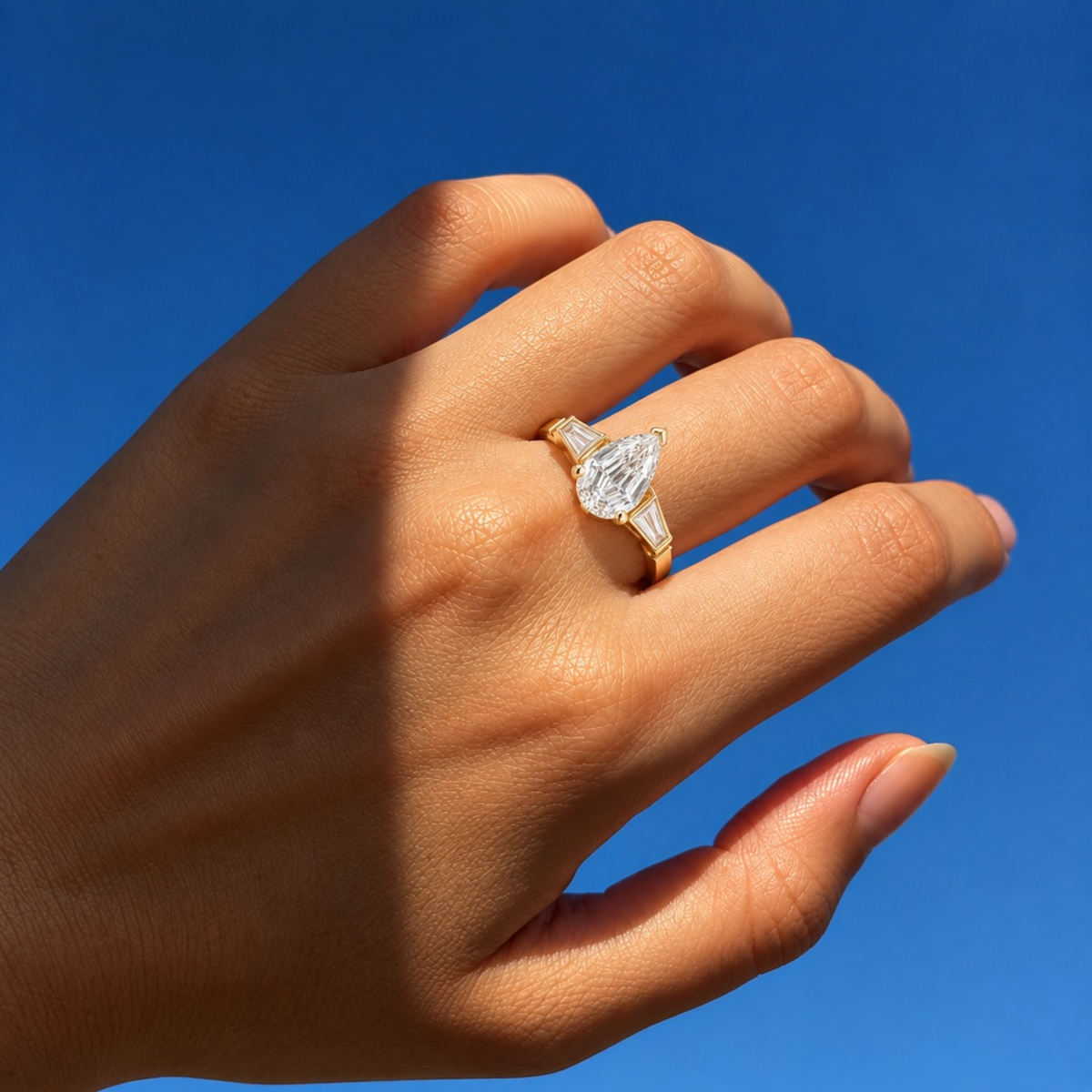 Lab Grown Diamond Pear Step Cut Three-Stone Tapered Baguette Side Accent Engagement Ring IGI Certified in 14K Yellow Gold