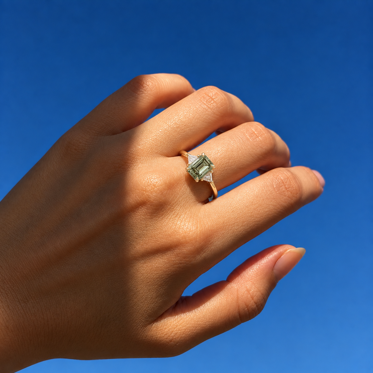 Lab Grown Green Emerald Cut Three Stone Engagement Ring with Trillion Diamond Side Accents in 14K Yellow Gold