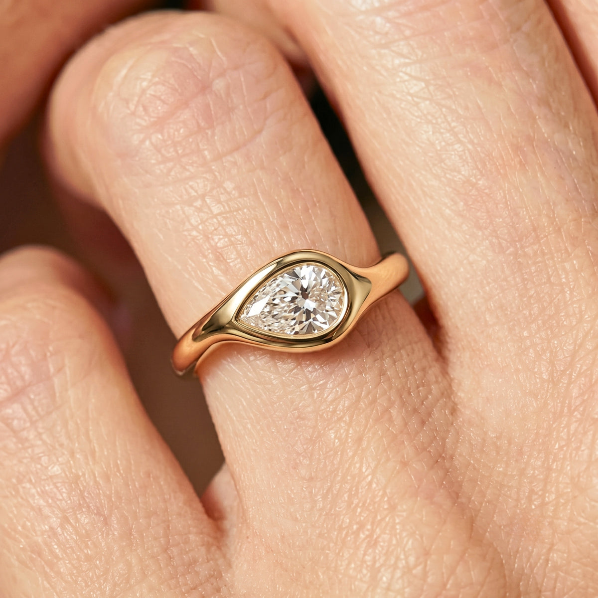 Lab Grown Diamond Pear Cut East-West Organic Wavy Bezel Engagement Ring IGI Certified in 14K Yellow Gold