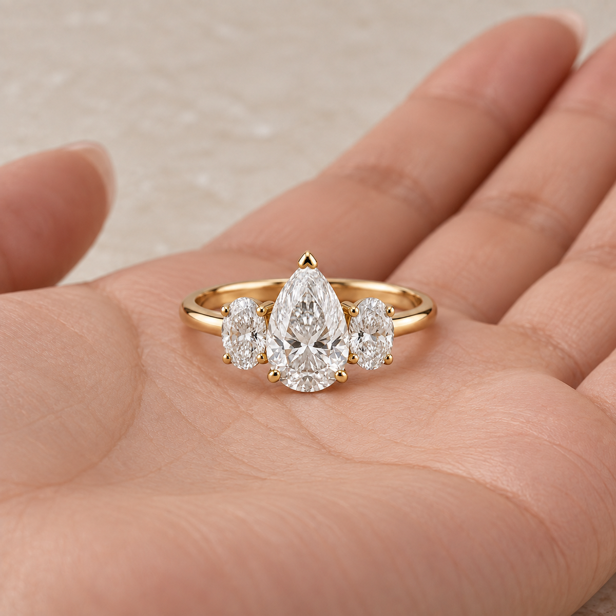 Lab Grown Diamond Pear Cut Three Stone Engagement Ring with Oval Side Stones in 14K Yellow Gold